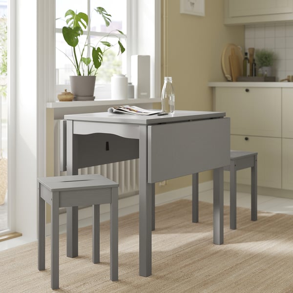 Cosy kitchen setup with grey HAUGA drop-leaf table & stools. Wooden, space-saving design with a modern look, perfect for small spaces.