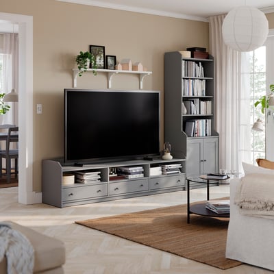 Modern living room with HAUGA tv bench, grey storage, tv, decor, sofa.
