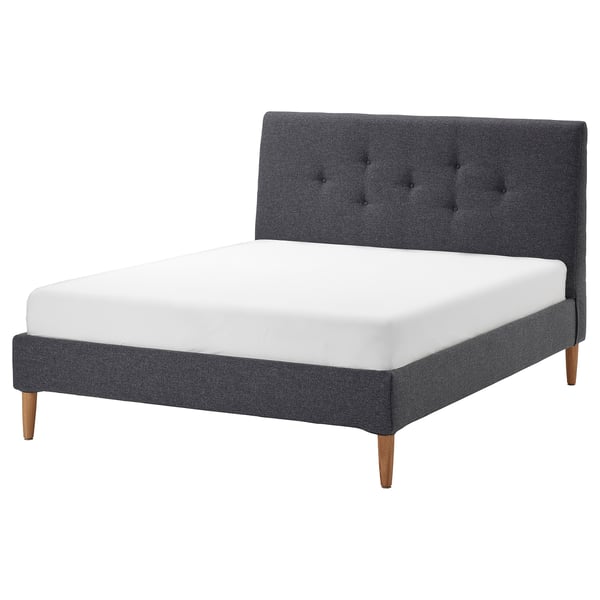 Modern grey upholstered bed with tufted headboard and wooden legs.