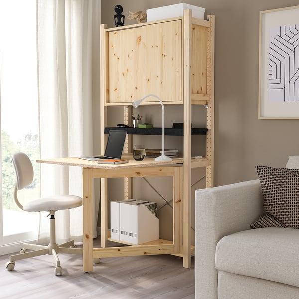Wooden IVAR desk with shelves, chair, and laptop. Natural finish, compact size.