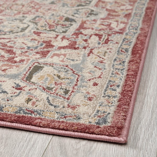 Bright, ornate rug with intricate floral patterns in soft pastels. High-quality, durable material, ideal for high-traffic areas.