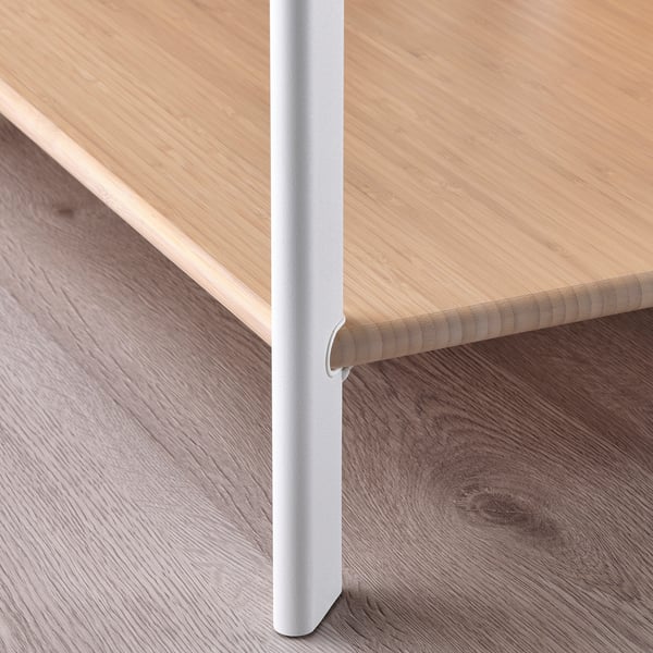 Youre viewing a modern table with sleek edges and smooth bamboo top, supported by sturdy metal legs.