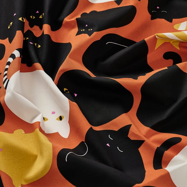Cute cat print fabric in vibrant colours, high-quality cotton, ideal for sewing projects.