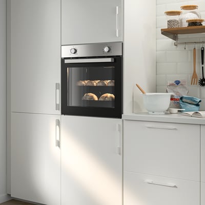 Modern kitchen with stainless steel oven and white cabinets