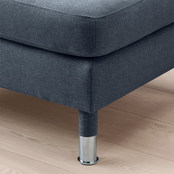 Close-up of a modern, grey upholstered footstool with chrome legs on a wooden floor.