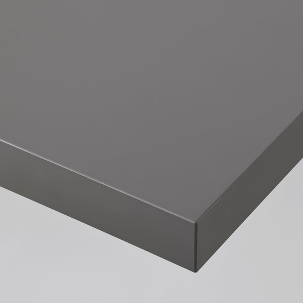 Close-up of black LINNMON table top. Smooth surface and sleek edges. Part of a modern, adaptable furniture set.