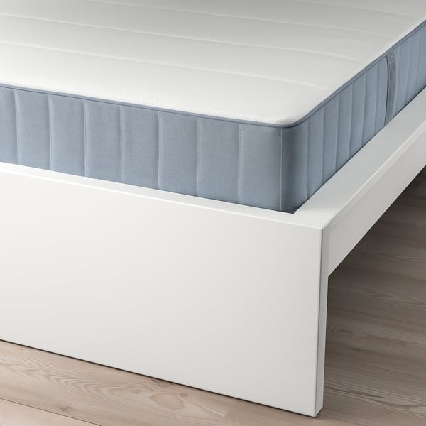 A white MALM bed frame with an adjustable, supportive mattress, showcasing slatted base for air circulation.