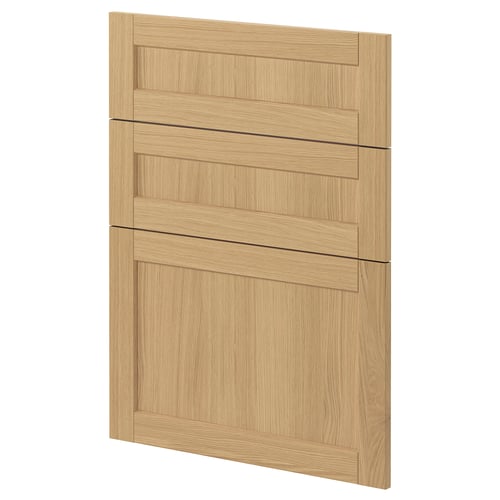 A light wooden cabinet door from ikeas METOD system, featuring oak veneer and beveled edges, designed for a classic kitchen look.