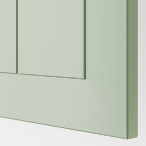 Light green kitchen cabinet close-up, smooth surface, sleek design.