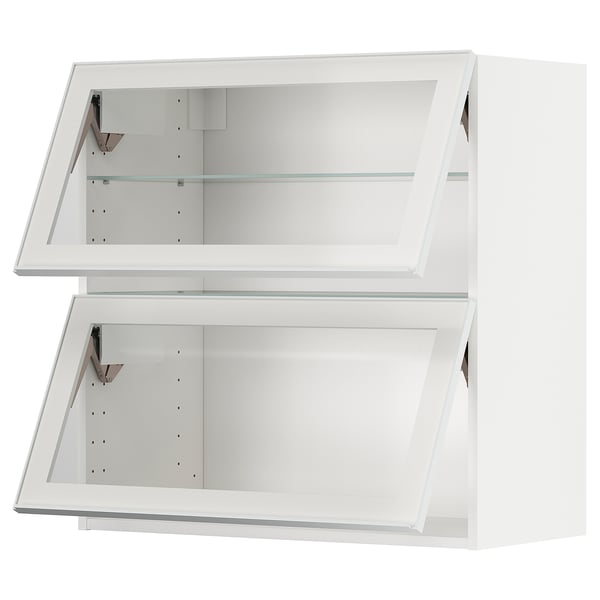 A white METOD kitchen cabinet with glass doors and metal frames.