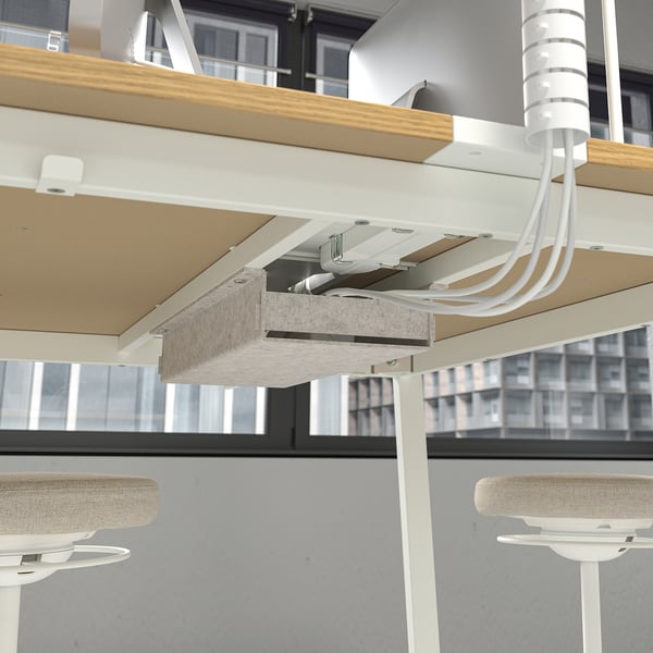Modern office table with integrated cable management and a footrest for comfort. Ideal for meetings.