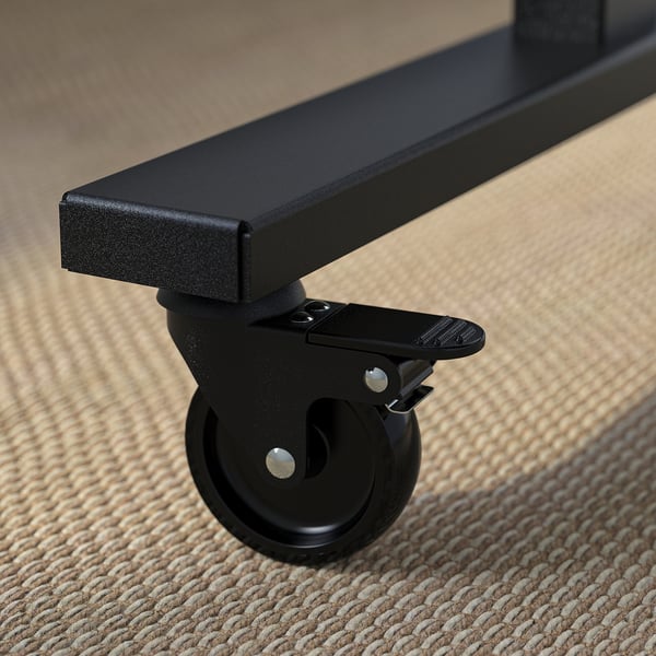 Close-up of high-quality, black office table caster with locking mechanism.