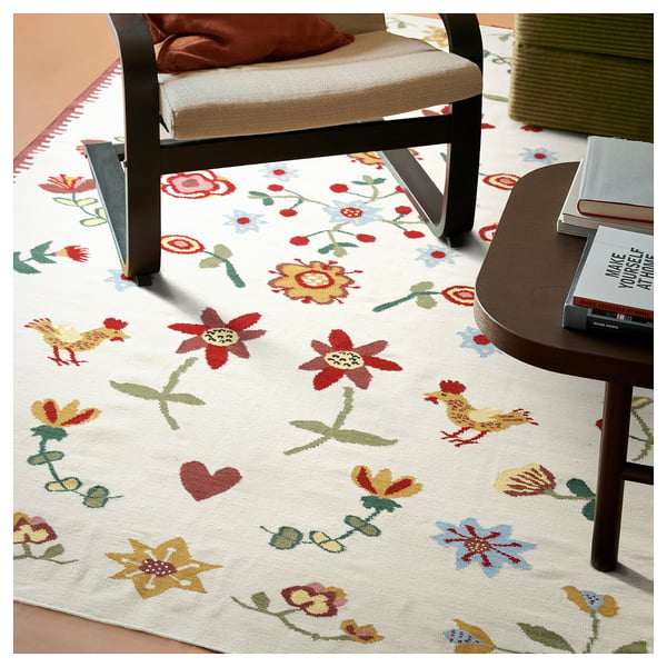 Colourful floral rug under black chair