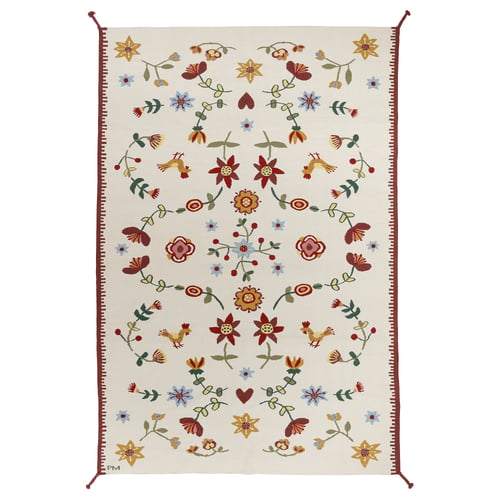 Nickgras rug, cream with red, yellow, blue flower designs, wool, cotton, braided corners.