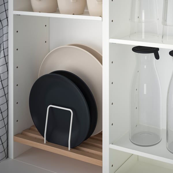 Kitchen shelf with foldable dining set and adjustable storage, organizing tableware and accessories.