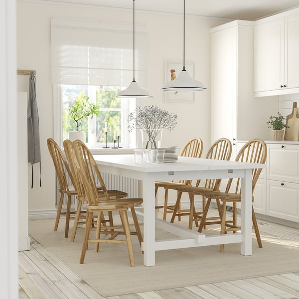 Extendable NORDVIKEN dining table with 8 chairs in bright kitchen.
