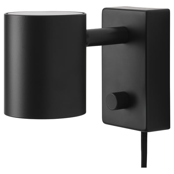 A black NYMÅNE wall lamp with a cylindrical shade and adjustable arm, mounted on a rectangular base.