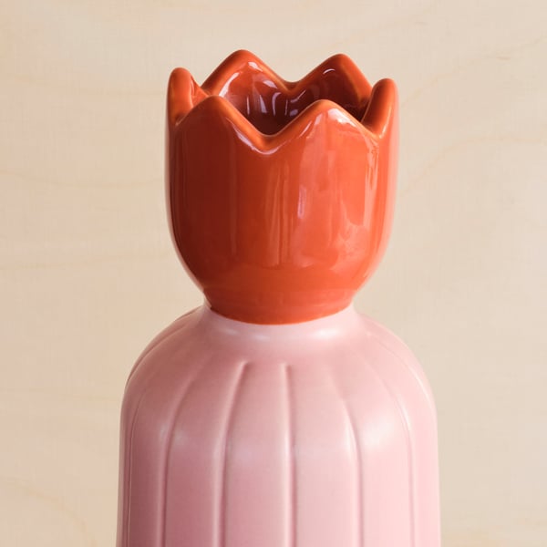 Unique, colourful glazed candle holder with ribbed design and petaled top. Brightens any setting with stylish elegance.