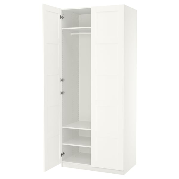 White PAX wardrobe, tall, rectangular with one open door revealing shelves and hanging rod.