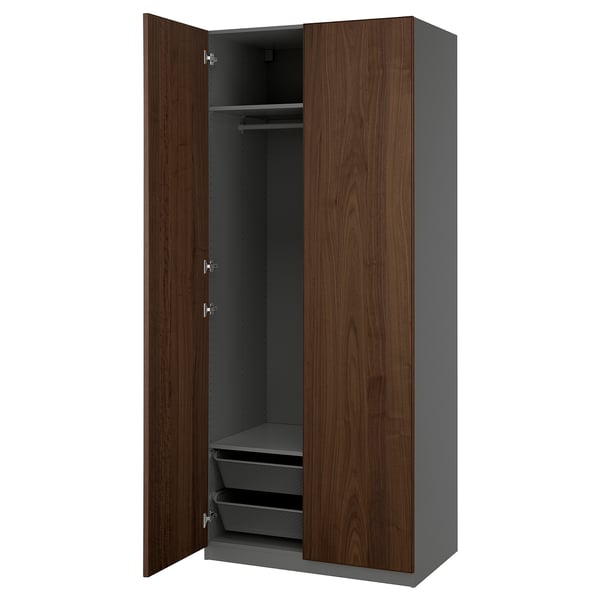 PAX wardrobe in walnut with gray interior, dark wood doors, hanging rail, and mesh baskets.