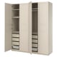 An open beige PAX wardrobe with drawers and shelves.