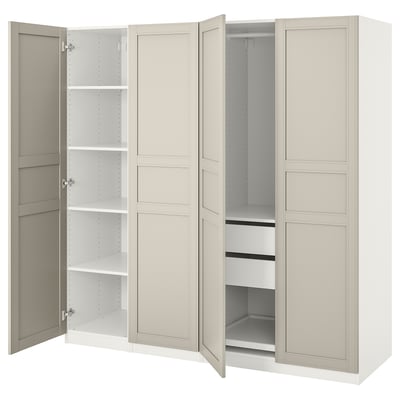 A white ikea PAX wardrobe with open doors, revealing adjustable shelves and compartments. The design is sleek and minimalist.