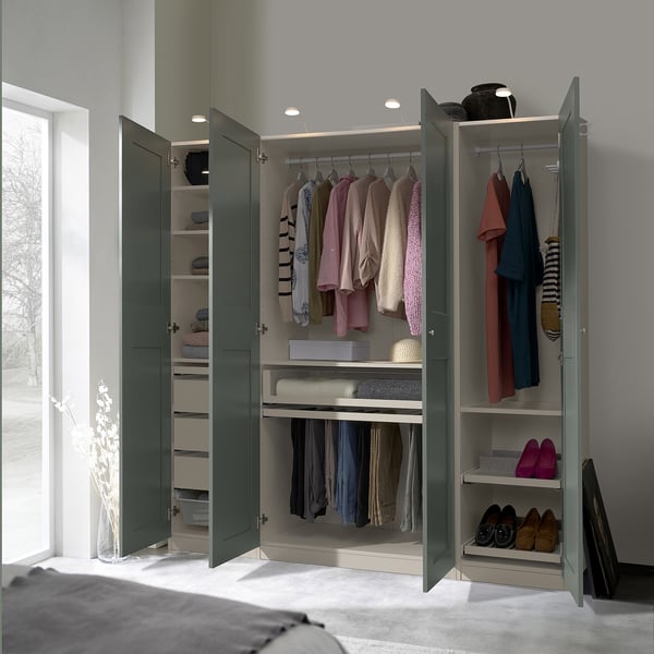 Open modern wardrobe displaying clothes, shoes, and accessories in a well-organized manner. Integrated lights illuminate the interior.