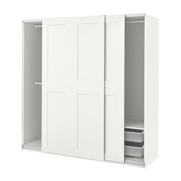 A white PAX wardrobe with sliding doors and shelves inside. Its sleek and modern, with a basic setup for easy organisation.