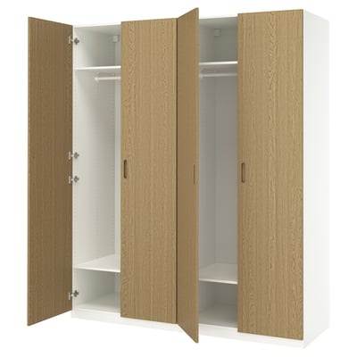 PAX wardrobe with light wood doors, fully open revealing white shelves, with handles and hinges.