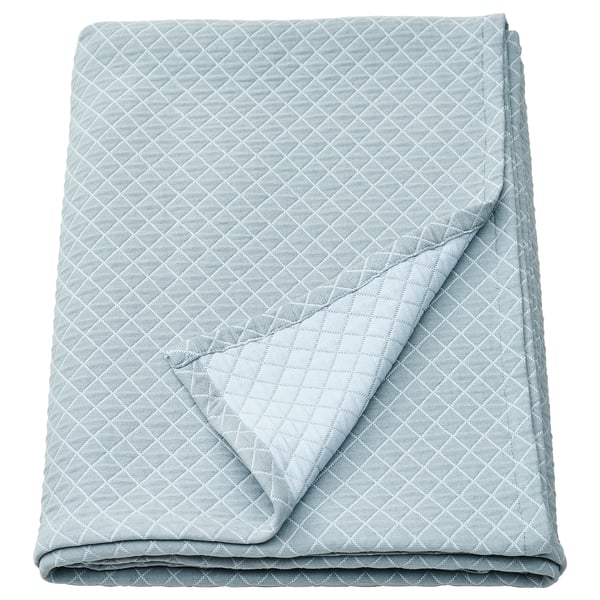 Folded light blue recycled polyester/cotton quilted bedspread with diamond pattern.