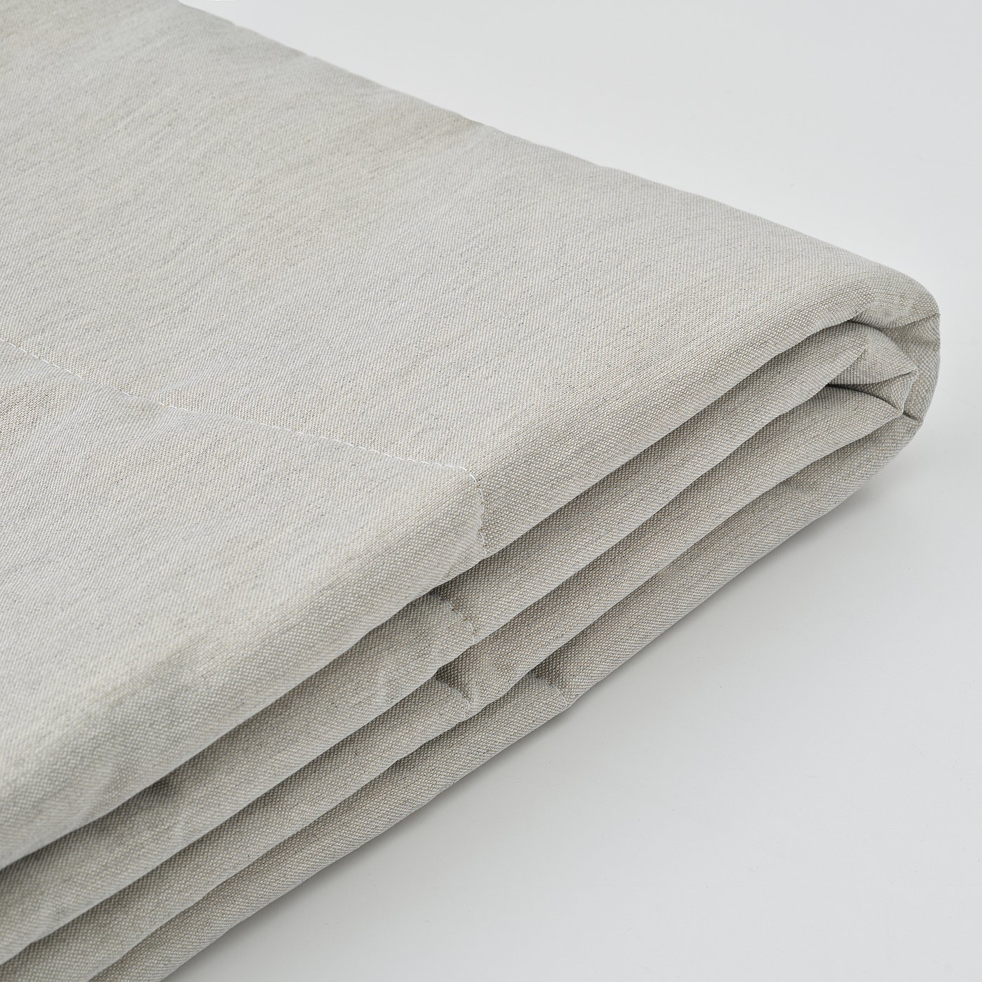 Folded light grey blanket, neatly pressed and stacked, showcasing smooth fabric texture.