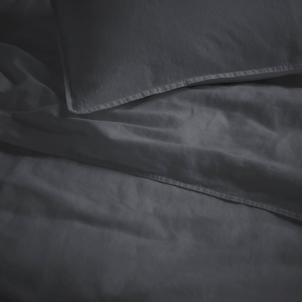 Soft, anthracite duvet set with smooth, wrinkled fabric, hinting at pre-washed softness and durability.