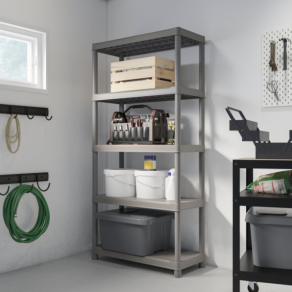 Grey 4-tier RUNMARÖ shelf with tools, near window & hose rack.