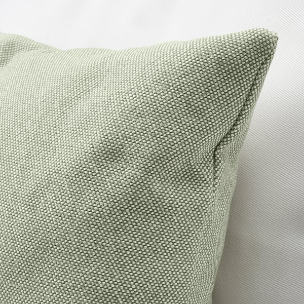 Light grey-green cushion with textured fabric, plump and soft, against a plain surface.
