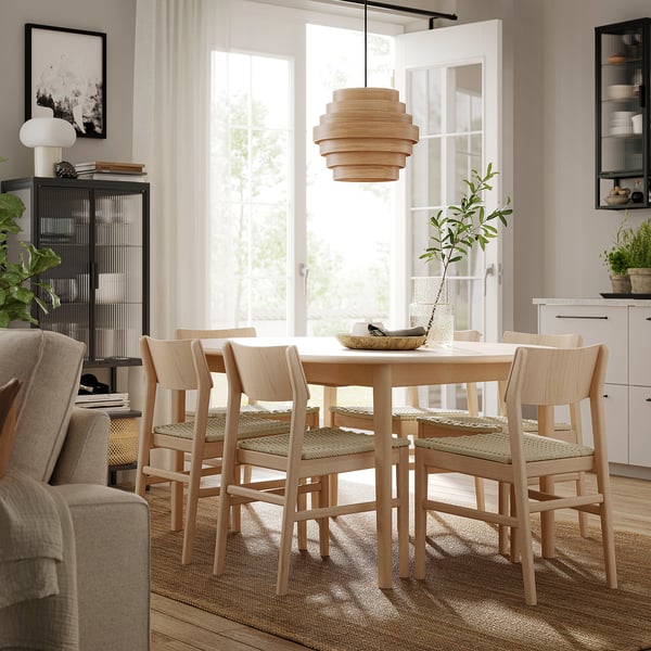 Modern oak dining set with pendant lamp, cosy decor.