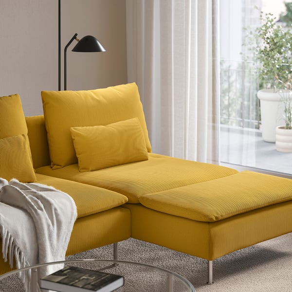 Bright yellow sofa with chaise, large cushions, and floor lamp beside it. Part of the SÖDERHAMN series, designed for comfort and relaxation.