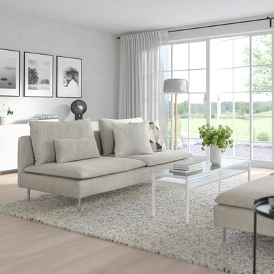 SÖDERHAMN sofa, beige, low and cosy, ideal for lounging. Placed centrally with a rug, scenic windows.