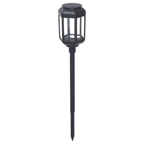 A black, cylindrical SOLVINDEN solar-powered outdoor lamp with a spike base. The shade is transparent polycarbonate, and it a modern design.