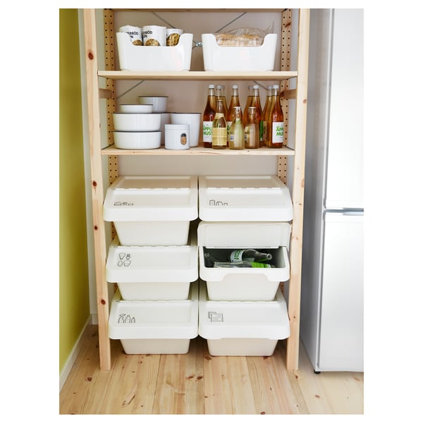 Wooden storage shelves with white bins and bottles, neatly organised. Stackable bins have folding lids for easy access.