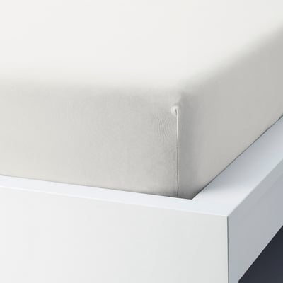 A fitted white sheet with elastic edges, perfectly fitting a mattress.