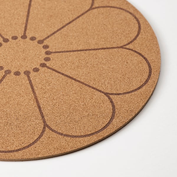 Circular cork coaster with engraved abstract design. Durable, eco-friendly, and stylish for table use.