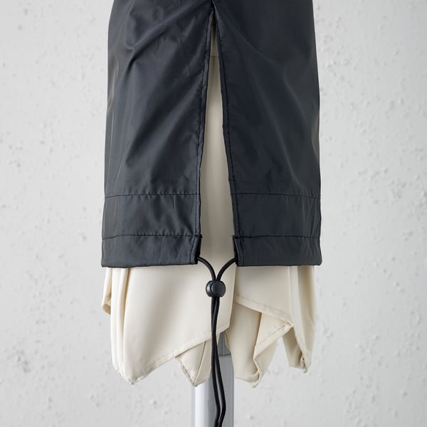 Waterproof parasol cover with drawstring, shown protecting a folded parasol.