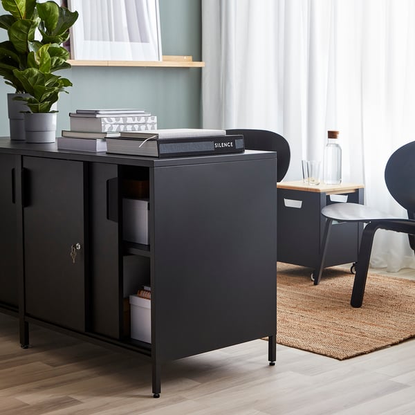 Double-sided cabinet, serving as a room divider, with adjustable shelves and lockable sliding doors.