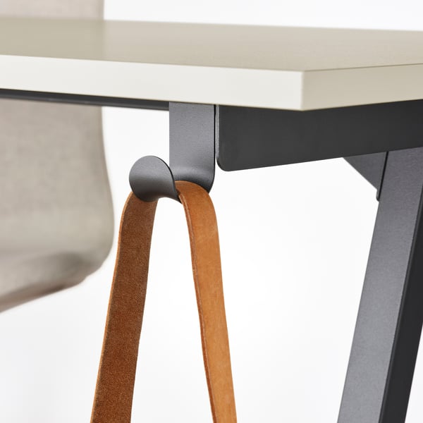 Desk with leather strap and metal hook for hanging items.