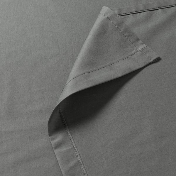 Close-up of high-quality, neatly stitched bedsheet with subtle texture, emphasising its smooth and durable fabric.