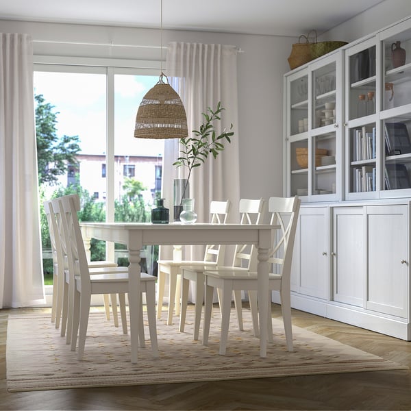 Modern dining room with VÄGNÄT rug, white furniture, city view window