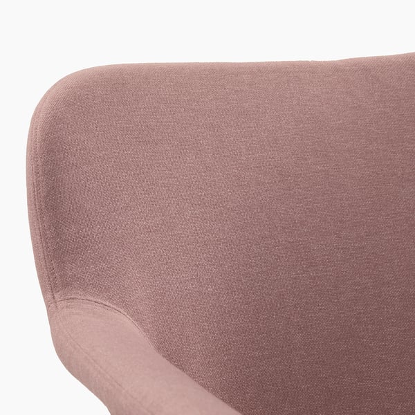 A close-up of a soft, textured pinkish-brown fabric armchair, showcasing its plush, inviting upholstery.