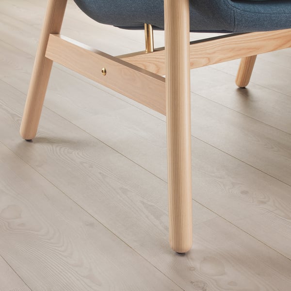 Light wood-finished VEDBO armchair with blue cushion, showcasing timeless design and quality craftsmanship.