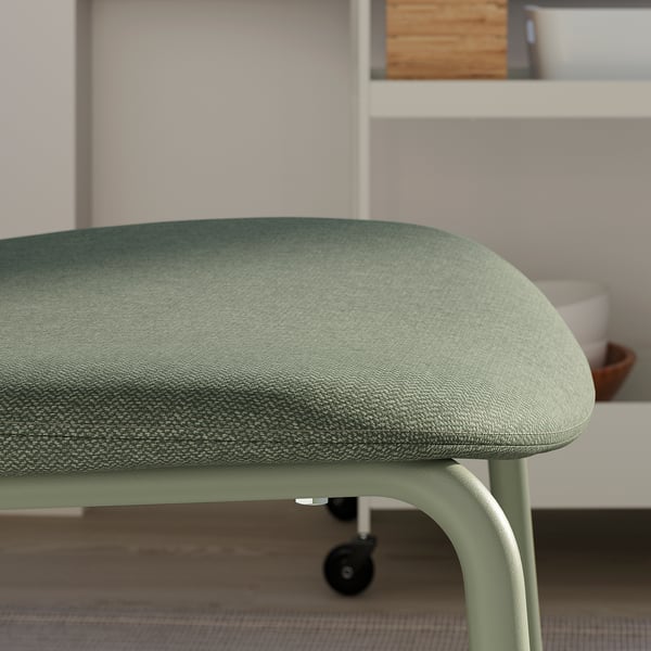 Modern green dining chair, sleek metal frame, high-quality fabric.