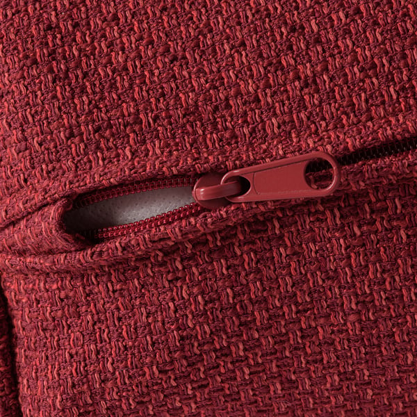 Close-up of red fabric with zip, showcasing texture and quality.